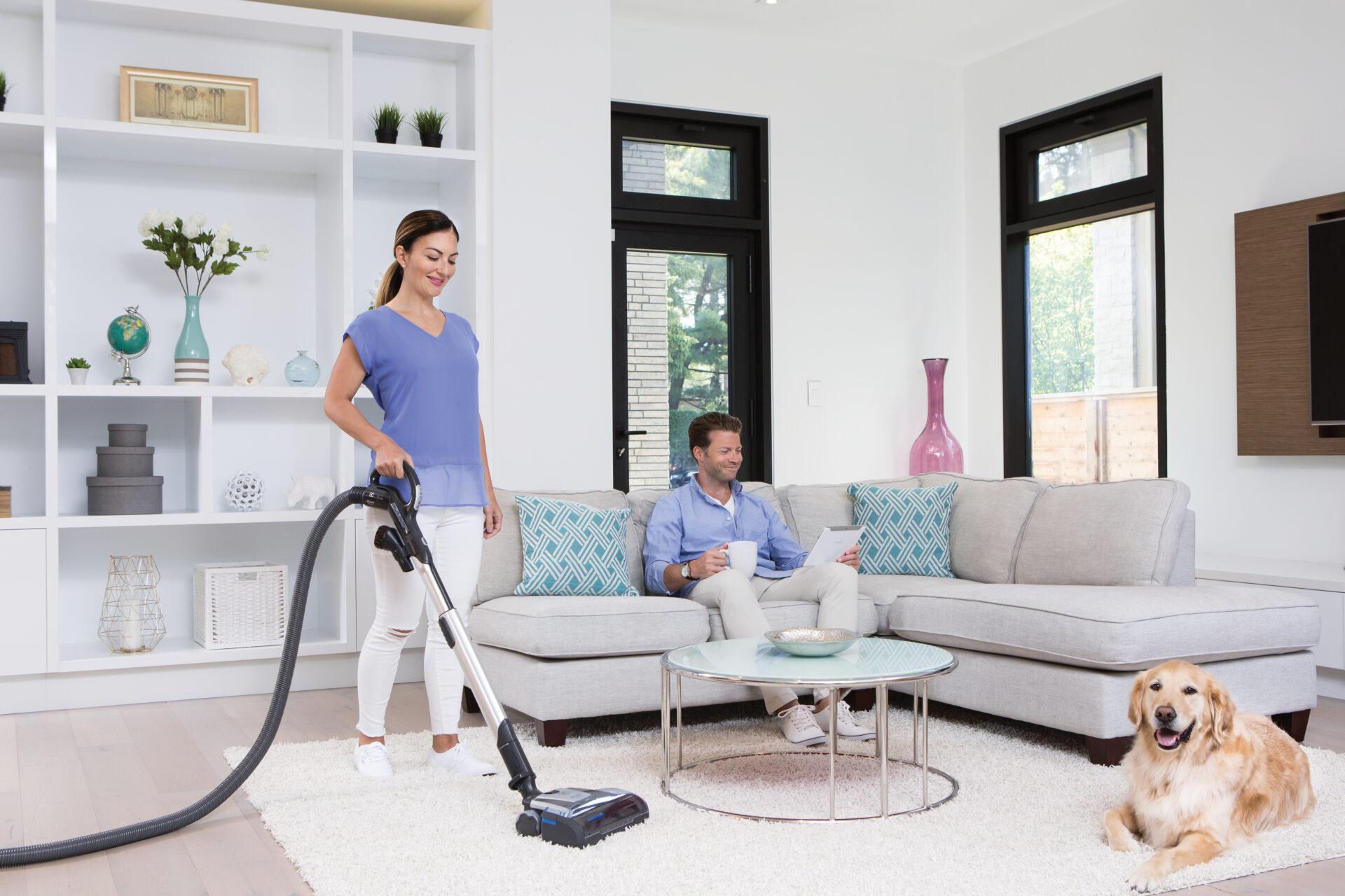 Family relaxing in a clean living room with a BEAM central vacuum powerhead
